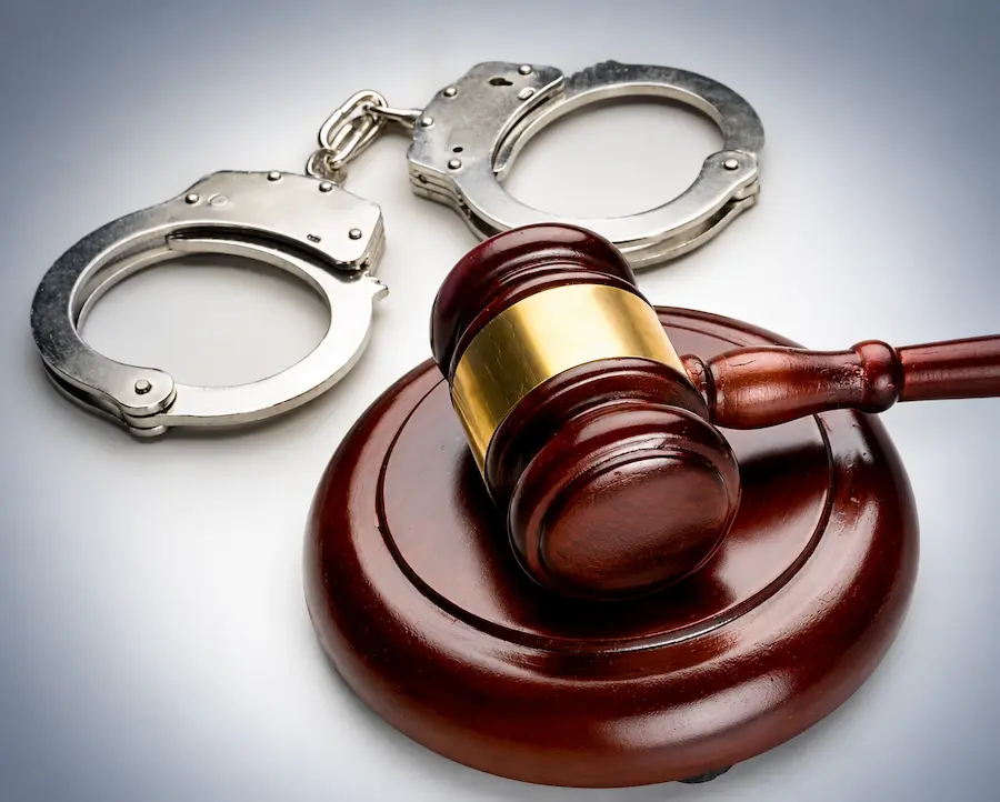 Gavel resting beside handcuffs – criminal defence lawyer for NSW Local Court matters