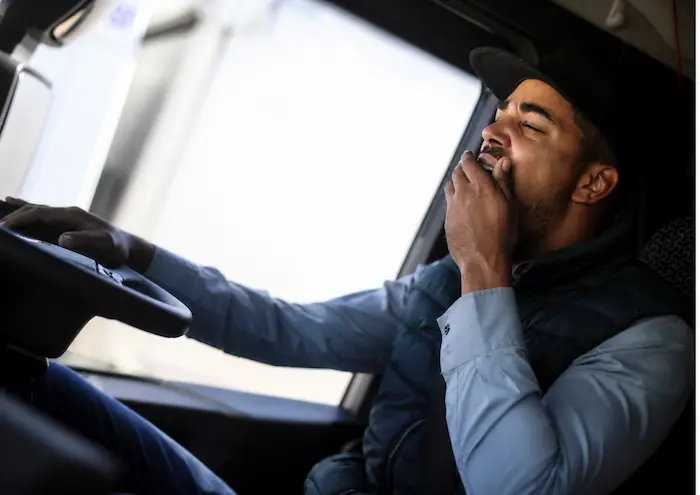 Tired truck driver showing signs of fatigue