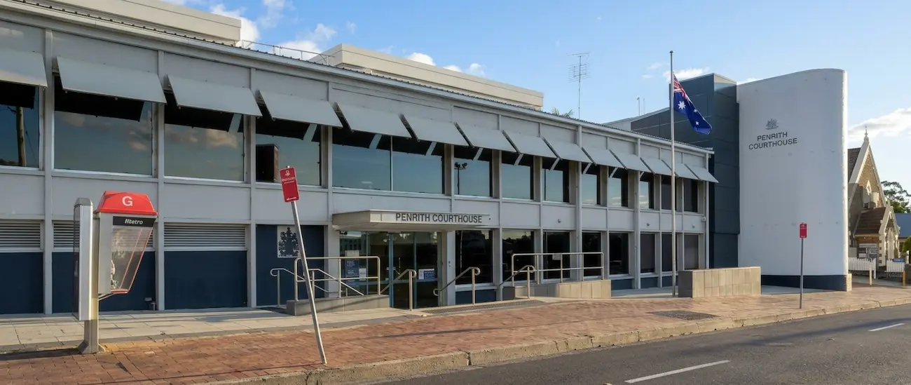 Two-storey Penrith Courthouse on Henry Street with the Australian flag outside, Penrith