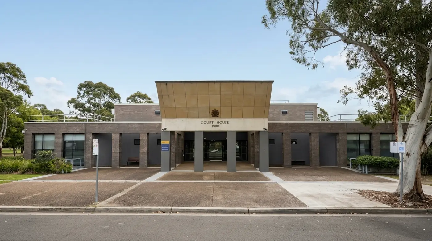 Single-storey brick Sutherland Court House with its copper-coloured entrance canopy, Sutherland