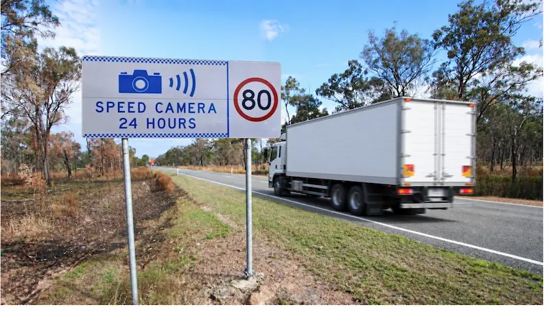 Truck speed camera sign on a NSW highway, where heavy vehicle speeding fines and demerit points apply